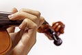 left hand of a young violinist on the strings on a student's violin on a light background. Royalty Free Stock Photo