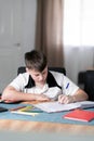 Left handed boy concentrated on doing his homework Royalty Free Stock Photo