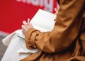 left - handed person writing on a notebook in cafe Royalty Free Stock Photo