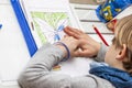 Left handed young boy working on his homework Royalty Free Stock Photo