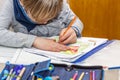 Left handed young boy working on his homework Royalty Free Stock Photo