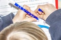 Left handed young doing his homework - Translation: read short time too pause sleeping burningif two consonants written Royalty Free Stock Photo