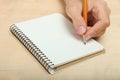 The left-hander writes in a notebook Royalty Free Stock Photo