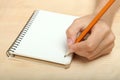 The left-hander writes in a notebook Royalty Free Stock Photo