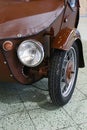 Left headlight and front wheel detail of Velorex 16/350, legendary small three-wheeled car designed for disabled