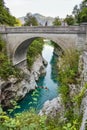 The Napoleon bridge near Kobarid in Slovenia. People are kajaking in the beautiful turquoise colored water of the Soca river Royalty Free Stock Photo