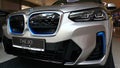 Left side detail of front mask and headlights of battery electric compact luxury crossover SUV BMW iX3. silver metallic colour Royalty Free Stock Photo