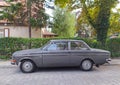 Old classic vintage veteran youngtimer grey car Volvo 142 parked in an old street on pave stones