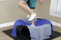 Left Side View of Male Legs Jogging on a Round Rebounder Closeup