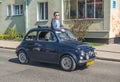 Classic vintage navy blue Fiat 500 driving