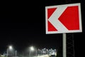 Left turn signs against the night sky and streetlights