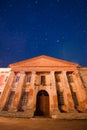 Left wing of palace of count Potocki in Tulchyn, Vinnytsia region, Ukraine, on a warm spring night against clear dark sky