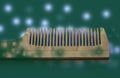 Wooden comb on a green background Royalty Free Stock Photo