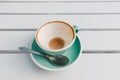 leftover coffee with foam in mug on the table in the cafe. Drained to the bottom of the drink