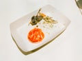 leftover fried chicken bones and leftover chili sauce in a cardboard box on a white table