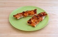 Leftover pizza crusts on green plate