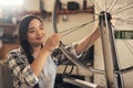 Lefty loosey, right tighty. a young woman working on a bike at a bicycle repair shop. Royalty Free Stock Photo