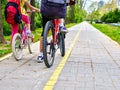 Leg of girls ride on bicycle.