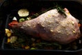 Raw Leg of lamb dressed with vegetables Royalty Free Stock Photo