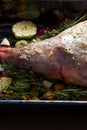 Raw Leg of lamb dressed with vegetables Royalty Free Stock Photo