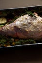 Raw Leg of lamb dressed with vegetables Royalty Free Stock Photo