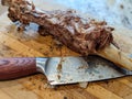 Leg of lamb roasted meat with a carving knife on a board