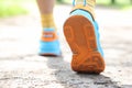 Leg of man taking step in sports sneakers closeup