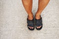 Leg of man is wear Sandals and standing on concrete road Royalty Free Stock Photo