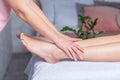 Leg massage therapy in spa salon, body care, skin care, wellness concept, spa woman