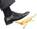 Leg in the right black shoe slips on a banana peel Royalty Free Stock Photo