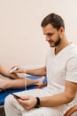 Leg ultrasound examination before surgery. Vascular surgeon examines arteries and veins of legs using portable Royalty Free Stock Photo