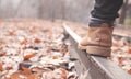 Leg of a woman in brown boot in autumn park Royalty Free Stock Photo