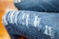 Leg of women in fragmentary and torn jeans
