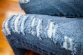 Leg of women in fragmentary and torn jeans