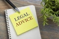 Legal Advice. Notepad with message, pen and flower. Office supplies on desk table top view