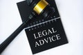 Legal advice text on black notepad with gavel on white background. Legal and law concept Royalty Free Stock Photo