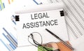 LEGAL ASSISTENCE text on the chart , office supplies, business concept