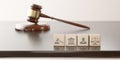 Legal Concept: judge's gavel hammer as a symbol of law and order and wooden cubes with icon