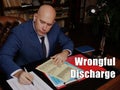 Legal concept about Wrongful Discharge Male office workers with yellow shirt holding and writing documents on office desk