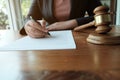 Legal counsel presents to the client a signed contract with gavel and legal law. Royalty Free Stock Photo