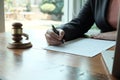 Legal counsel presents to the client a signed contract with gavel and legal law. justice and lawyer  law of advisor Concepts Royalty Free Stock Photo