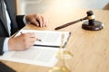 Legal counsel presents to the client a signed contract with gavel and legal law. justice and lawyer concept Royalty Free Stock Photo