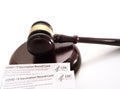 Legal gavel and US CDC COVID-19 Vaccination Record card