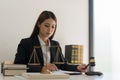 Legal and justice concept, Female lawyer holds hammer and writes contract and agreement of business