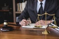 Legal law, advice and justice concept, Judge gavel with Justice lawyers, Counselor in suit or lawyer working on a documents in Royalty Free Stock Photo