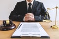 Legal law, advice and justice concept, male lawyer or notary working on a documents and report of the important case and wooden g Royalty Free Stock Photo