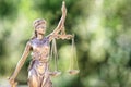 Legal law concept statue of Lady Justice with scales of justice with green background Royalty Free Stock Photo