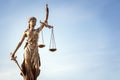 Legal law concept statue of Lady Justice with scales of justice with blue sky background Royalty Free Stock Photo