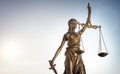 Legal law concept statue of Lady Justice with scales of justice sky background Royalty Free Stock Photo