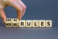 Legal or moral rules symbol. Businessman turns wooden cubes and changes words `legal rules` to `moral rules` on a beautiful gr